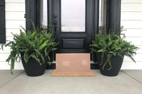 Picture of amazon package on front porch for amazon delivered to wrong address.