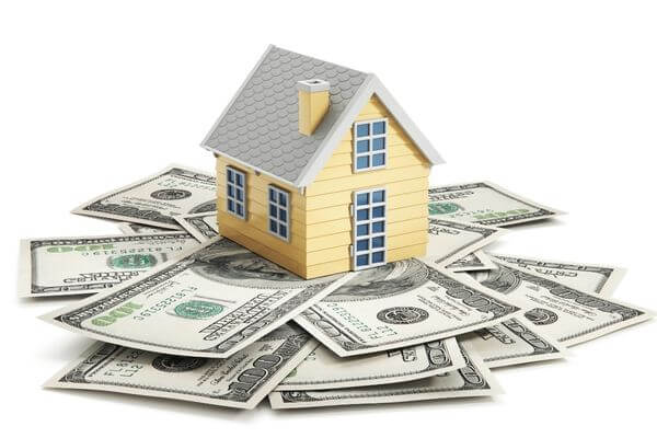 Picture of a house on top of cash for how much cash can you keep at home legally.