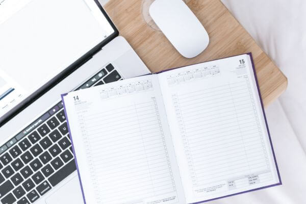 Picture of laptop and calendar planner.