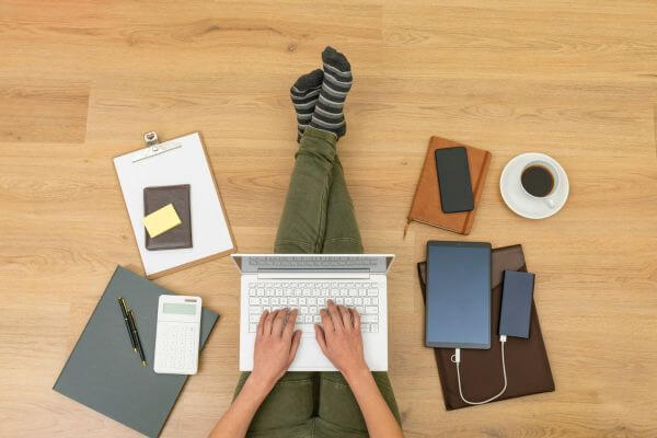 Picture of a lady researching on a laptop.