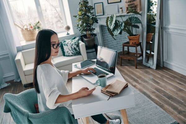 Picture of a lady paying bills.