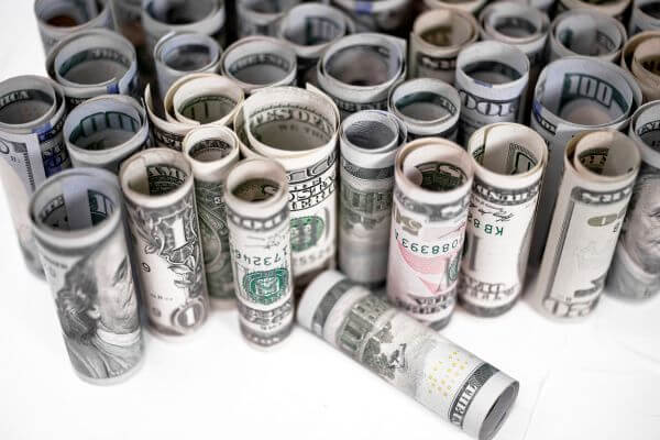 Picture of rolled bills for what is needed to make a money cake.