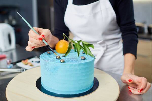 Picture of someone making a cake. bb