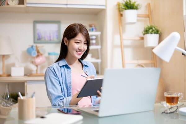 Picture of someone writing content for a blog with a laptop.