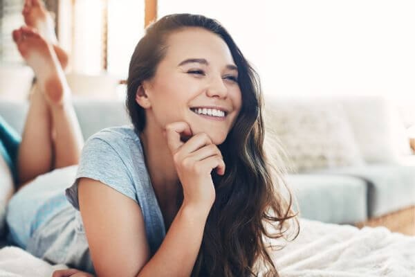 Picture of a lady relaxing on a couch.