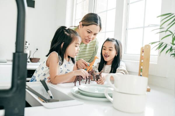 Picture of a lady playing with her kids.