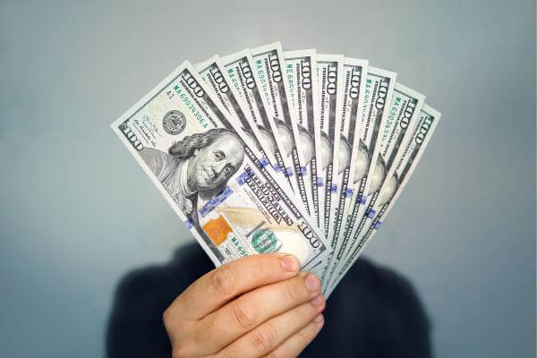 Picture of someone holding up money for how to build passive income streams