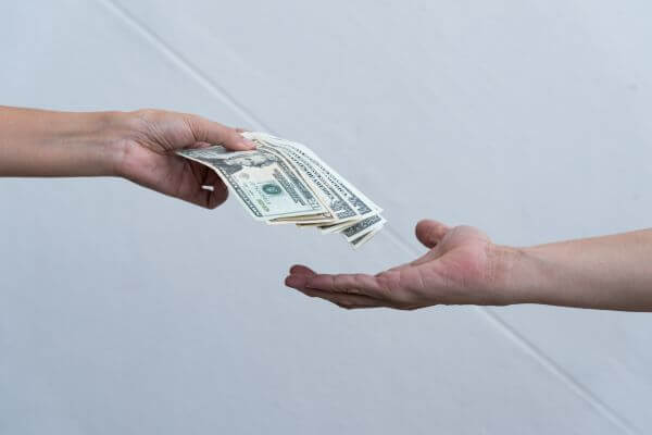 Picture of cash transferring from hands.