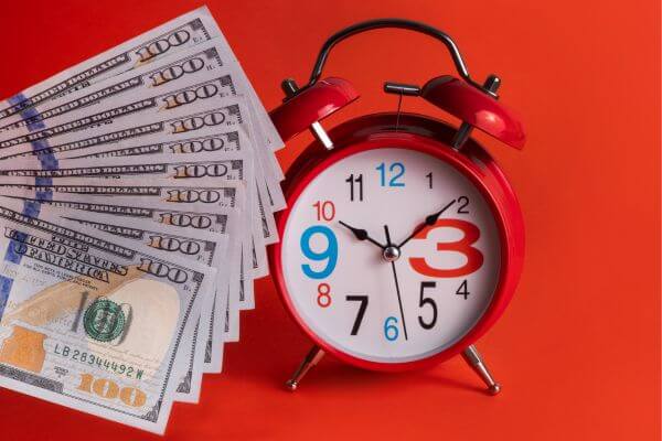 Picture of hundred dollars bills and a clock for how can I make a lot of money in hours.