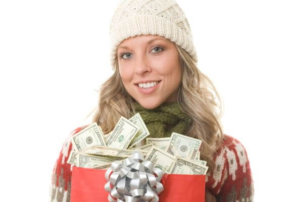 Picture of a lady holding a money gift present filled with cash.