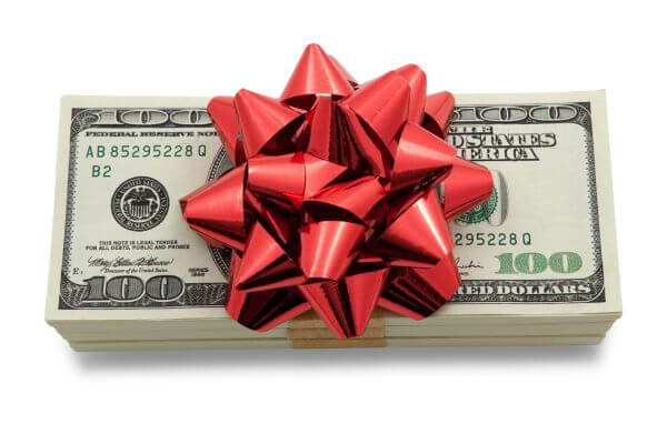 Picture of hundred dollar bills with a bow on top for savings with Christmas on a budget