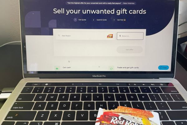 Picture of gift card on laptop to sell it.