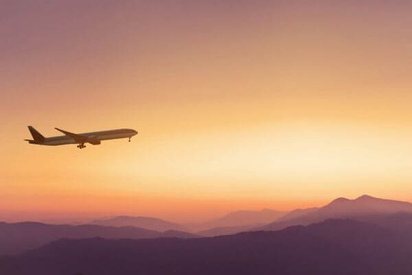 Picture of a plane taking off at sunset.