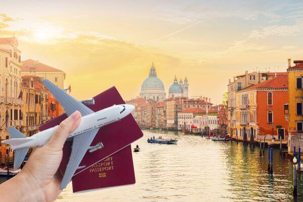 Picture of Venice with a plane and passports on front to make sure you are prepared with these Amazon travel must haves