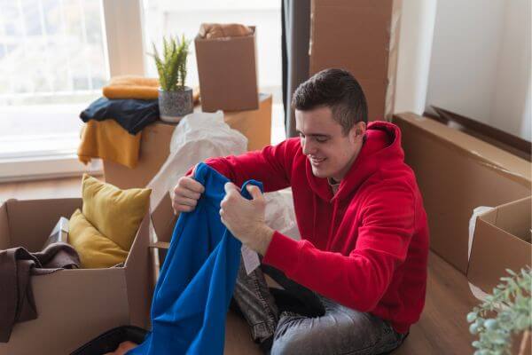 Picture of a college student unpacking a care package.