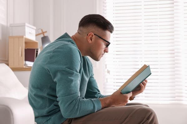 Picture of a guy reading life changing books for success