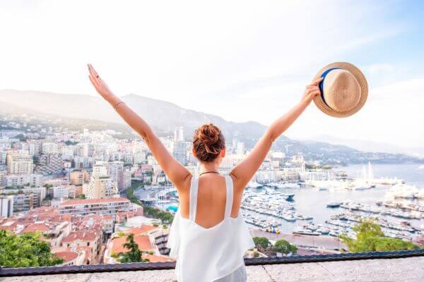 Picture of a lady excited to be traveling with her best travel essentials.