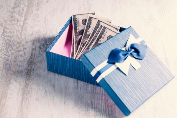 Picture of hundred dollar bills in a box for money gift box ideas.