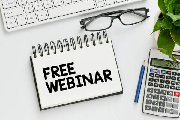 Image of a poster of free webinar with a keyboard, eyeglass, pencil, a calculator in a table. 