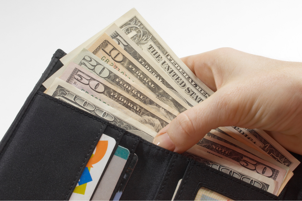 Image of a dollar bill in a wallet and cards.