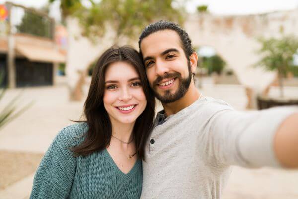 Image of a lover taking a selfie together in a park for memories to keep.