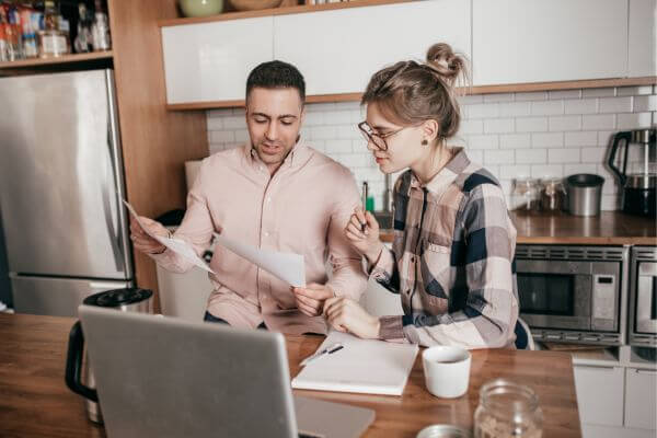 Picture of a couple looking at finances for how much will I get if I claim my girlfriend as a dependent.