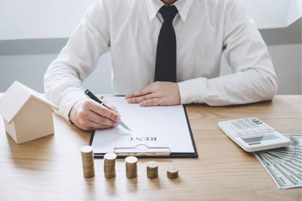 Image of a man writing down the tips to maximize the rent budget.