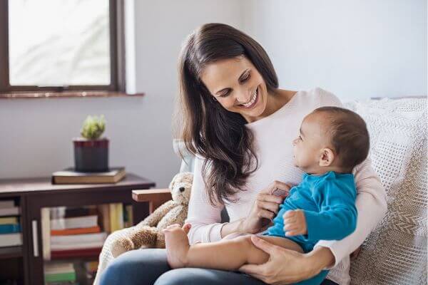 Image of a woman and a baby doing a babysitting.