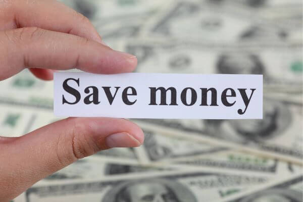 Picture of the woman holding a piece of paper with a context of save money and dollar bills around.