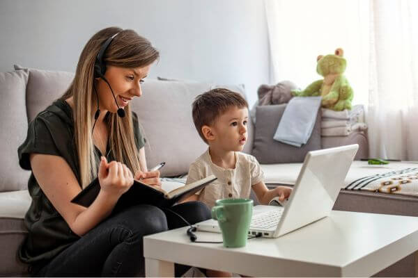 Image of a mom working on her job as a side hustle job as a mom.  