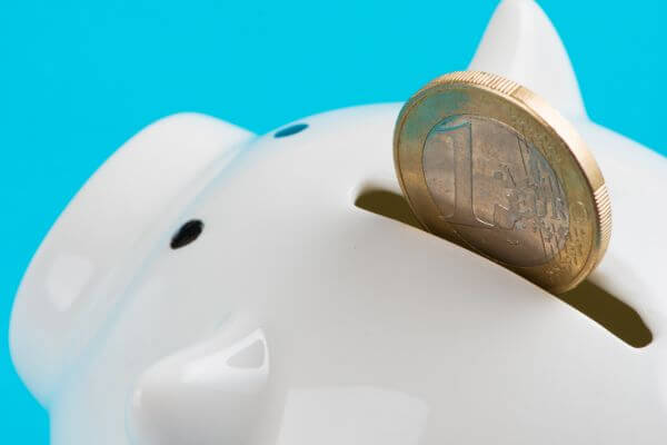 Picture of the piggy bank and a penny coin as an example of mini savings challenge.