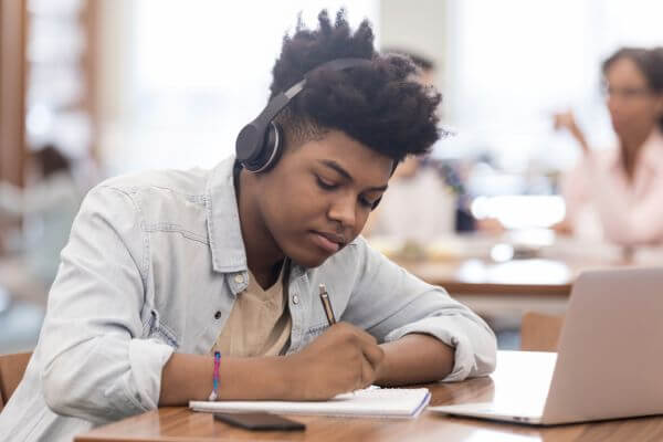 Picture of a teen reviewing a music as one way to earn money.