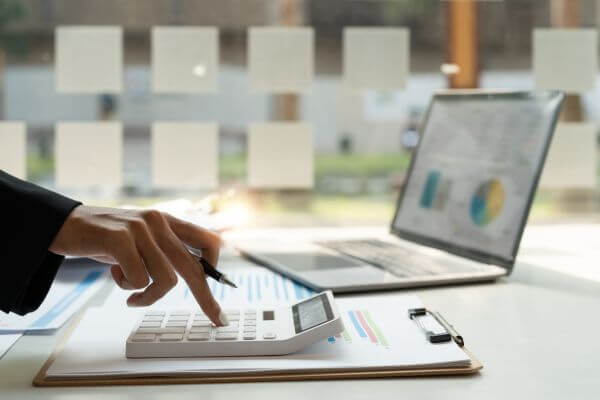 Picture of teacher working on the financial bookkeeper as one ways to earn money.