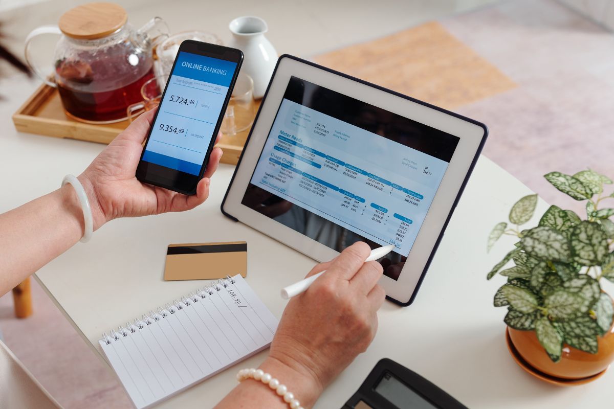 The picture of the woman identifying and prioritizing paying the bills and expenses through online banking.