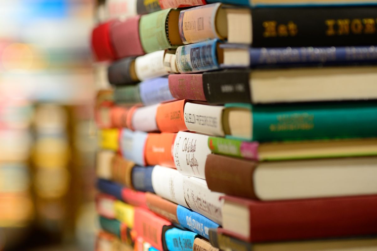 Image of the personal finance books piled in different colors.