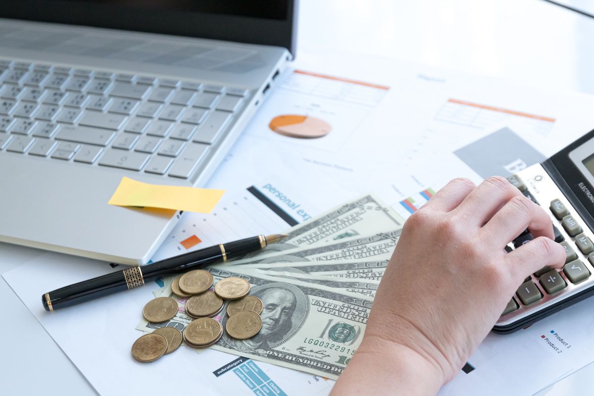 Photo of a woman's hand budgeting her money.