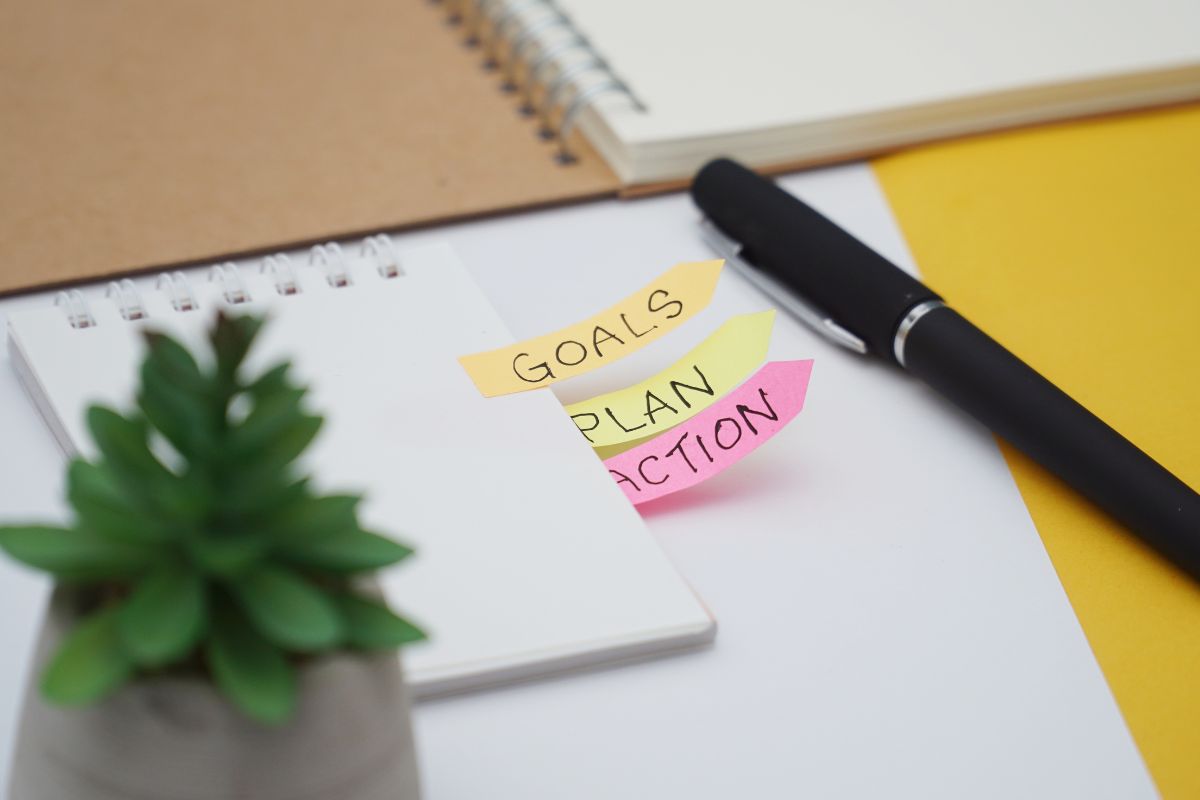 Image of a notebook with goals, plan, and action notes.