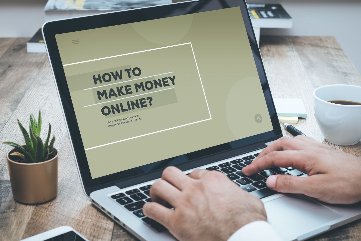 A man's hand learning how to make money online.