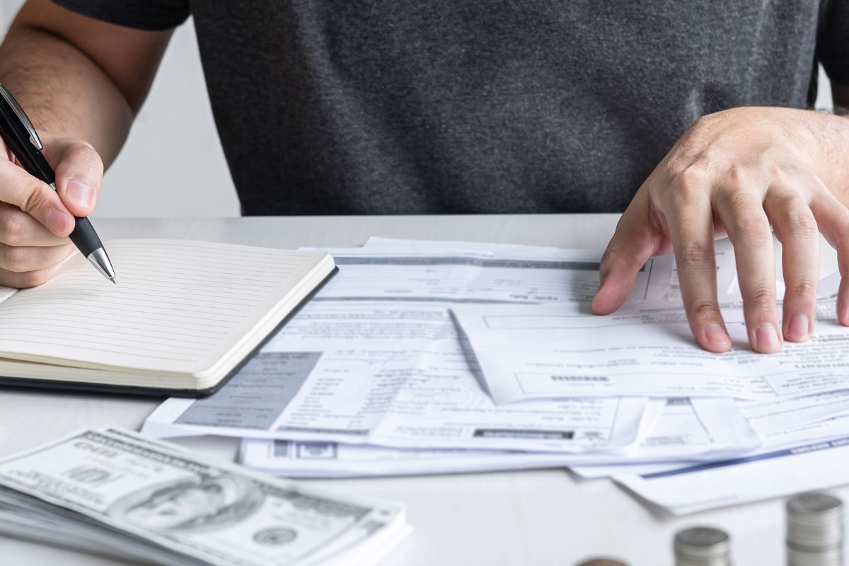 Photo of a man defining his bills and expenses.
