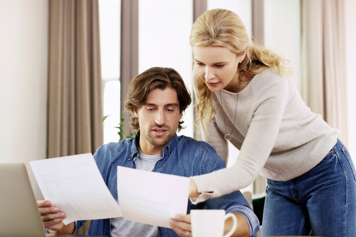 Image of a couple figuring out their monthly income.