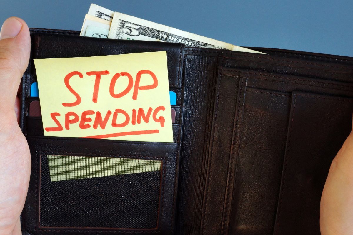 Image of a wallet with stop spending note.