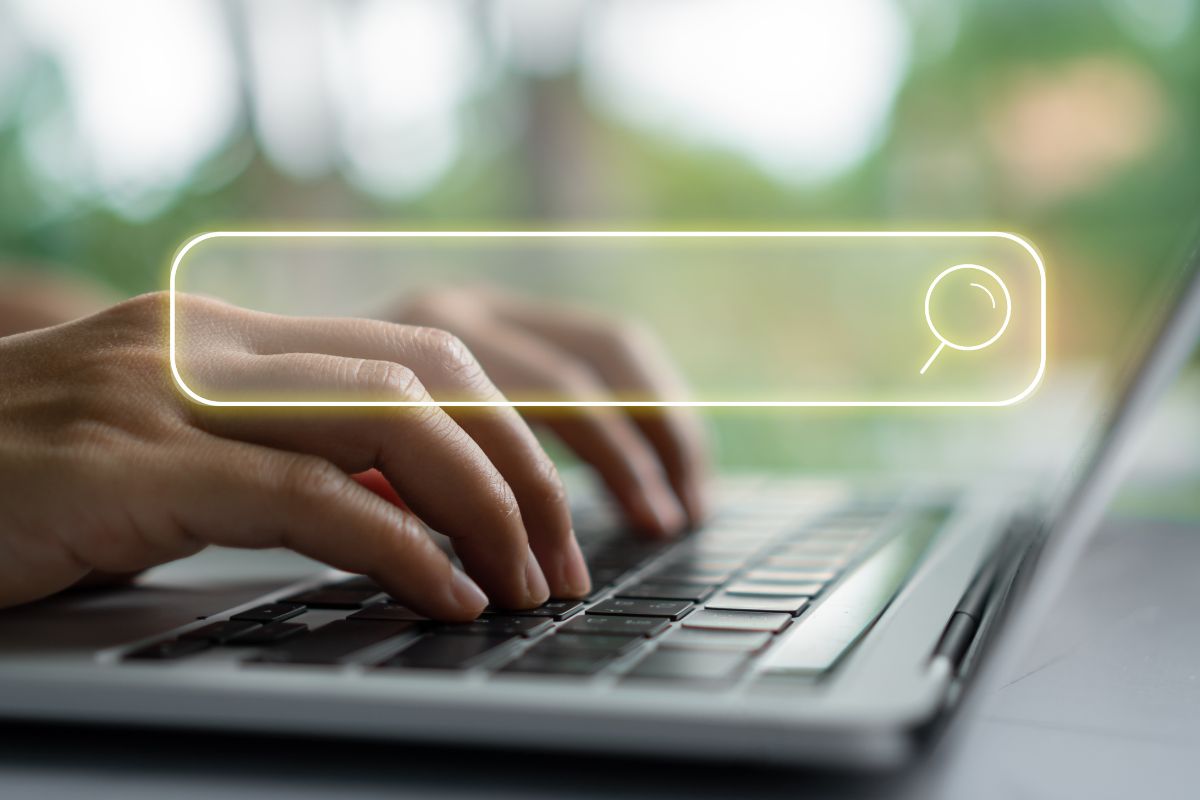 Image of a woman's hand searching ways online.