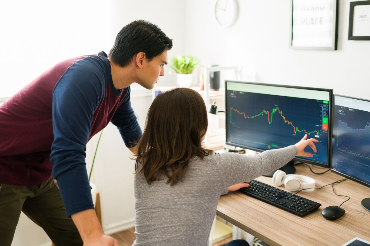 The picture shows a man taught about investing in stocks.
