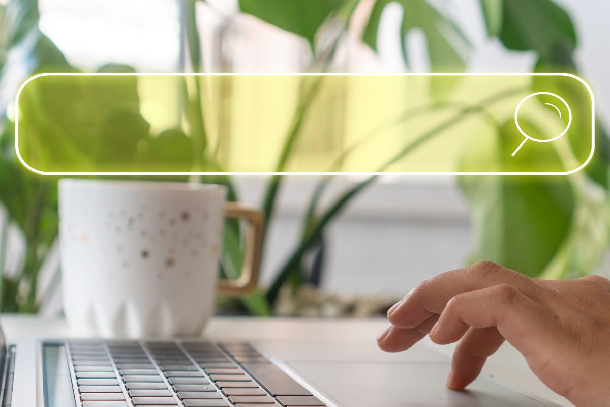 A woman's hand using a laptop.