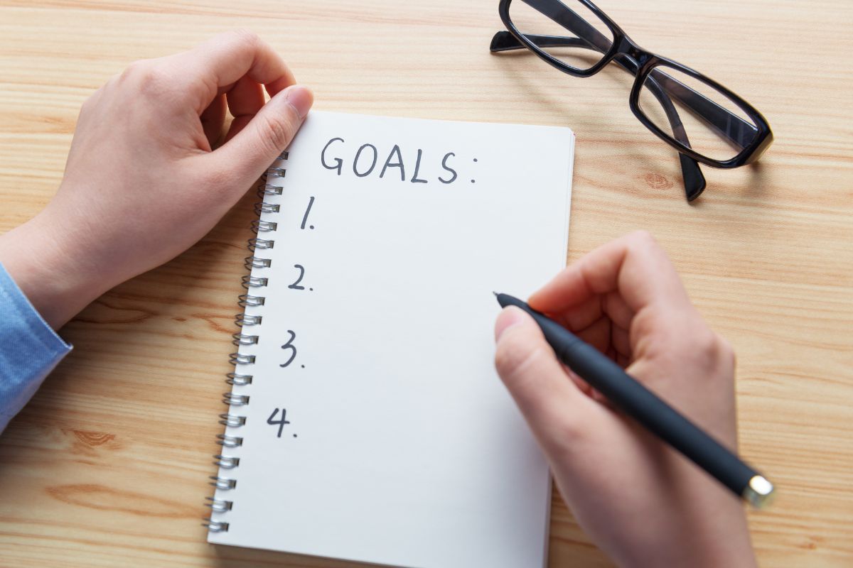 A woman's hand setting goals.