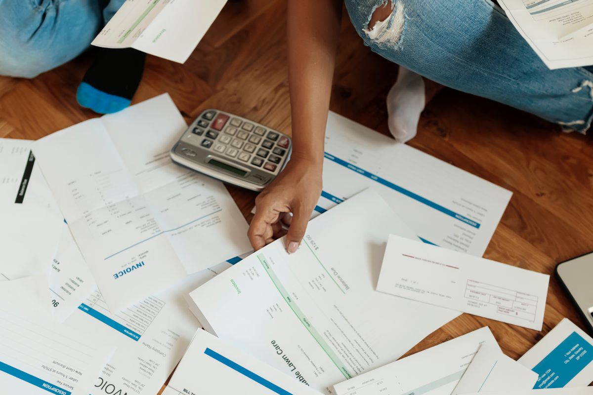 A man's hand managing debt.