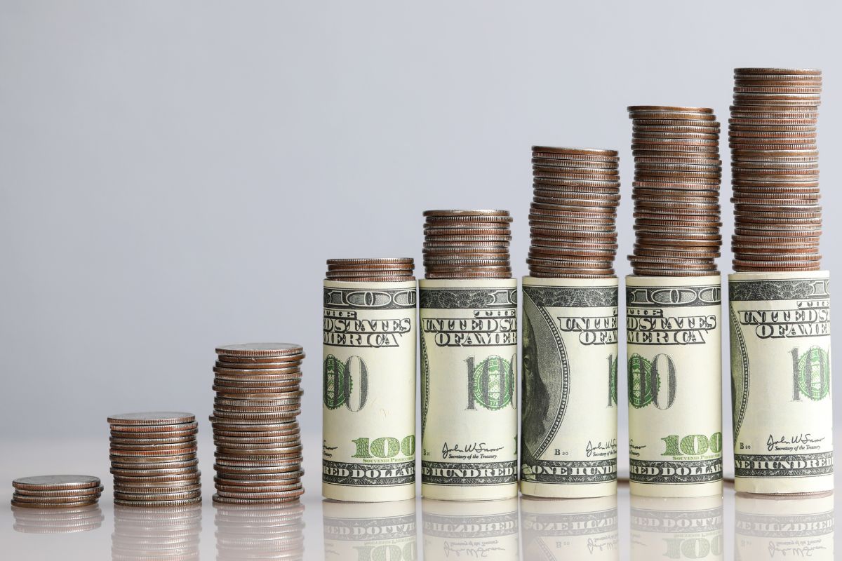 The photo shows stacks of money.