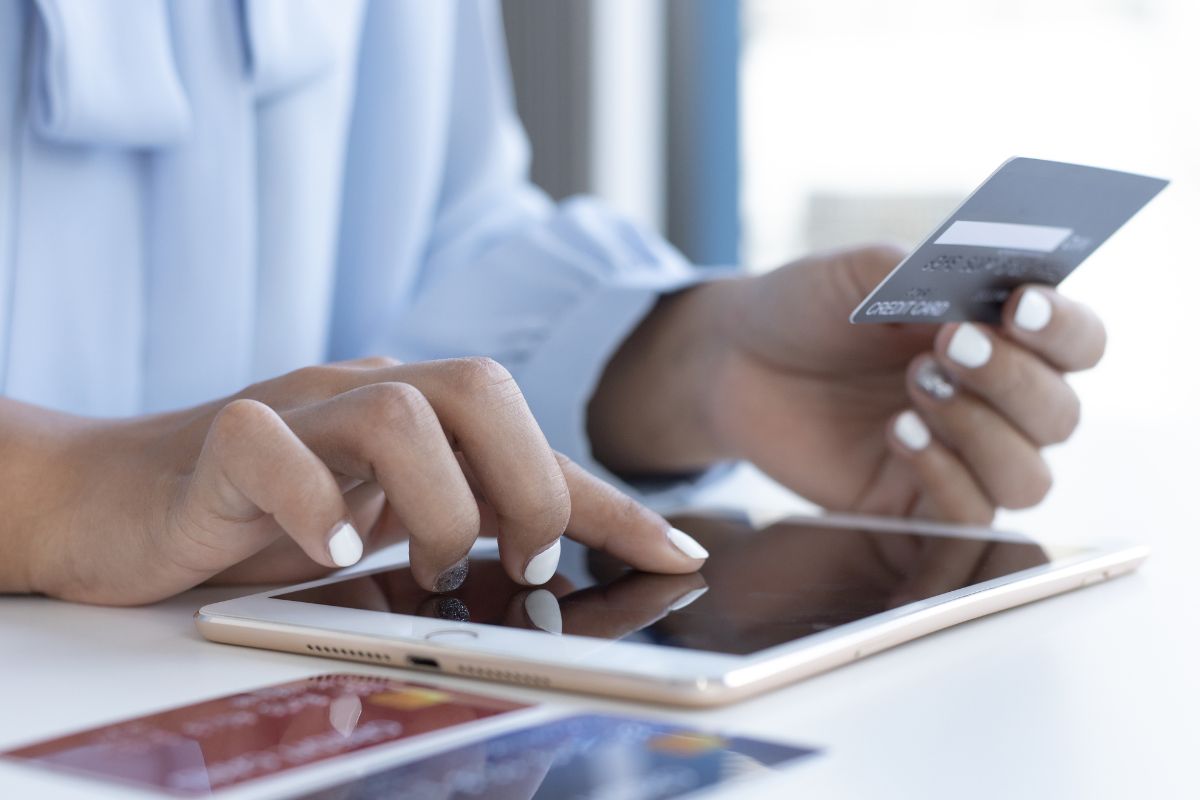 The picture shows a woman using a credit card.