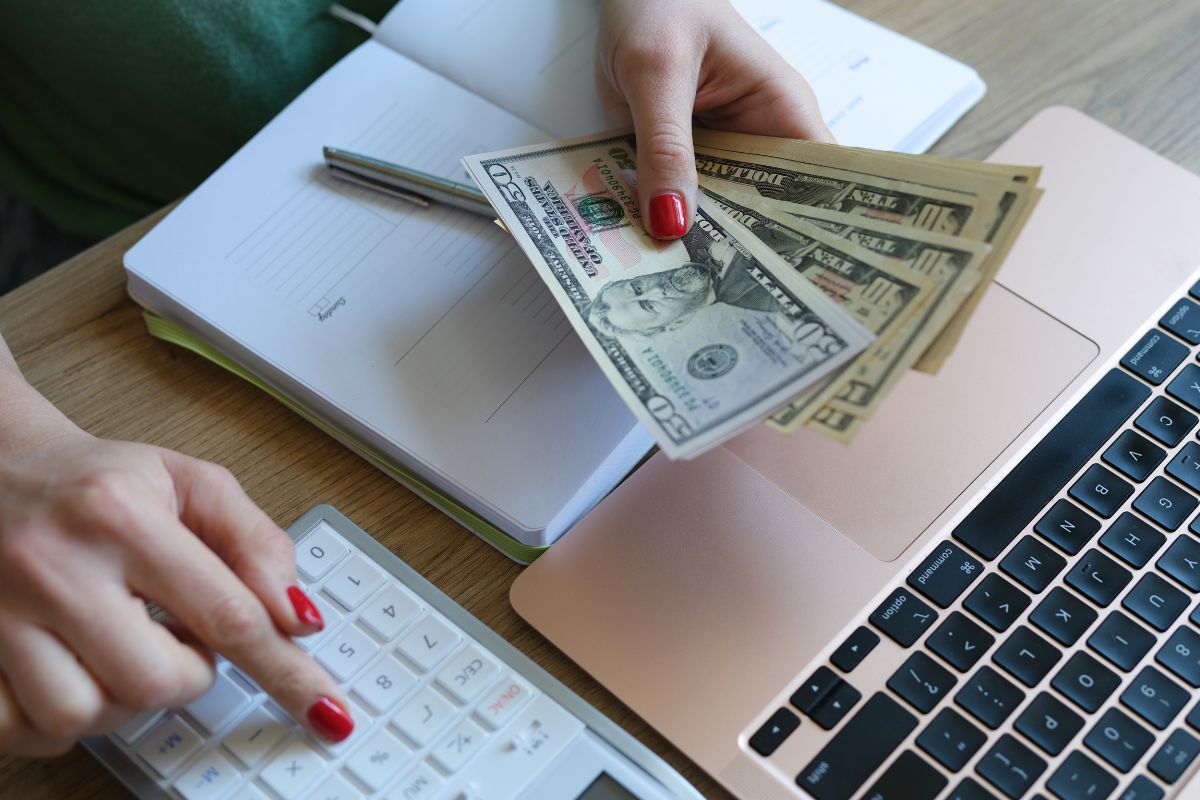 The photo shows a woman budgeting money.