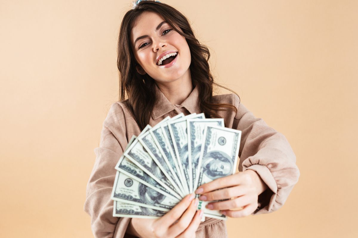 The picture shows a woman holding money.